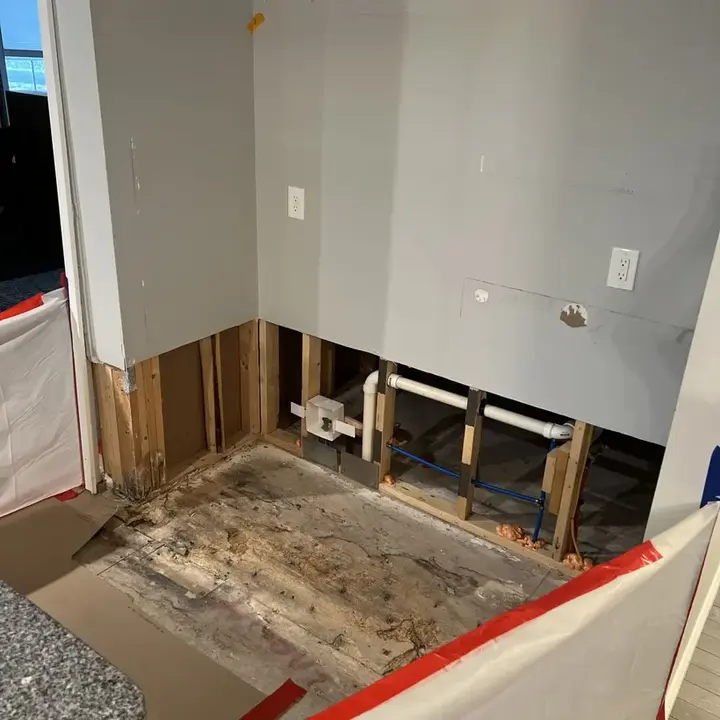 Wet drywall cut away to dry a kitchen wall cavity in Manchester