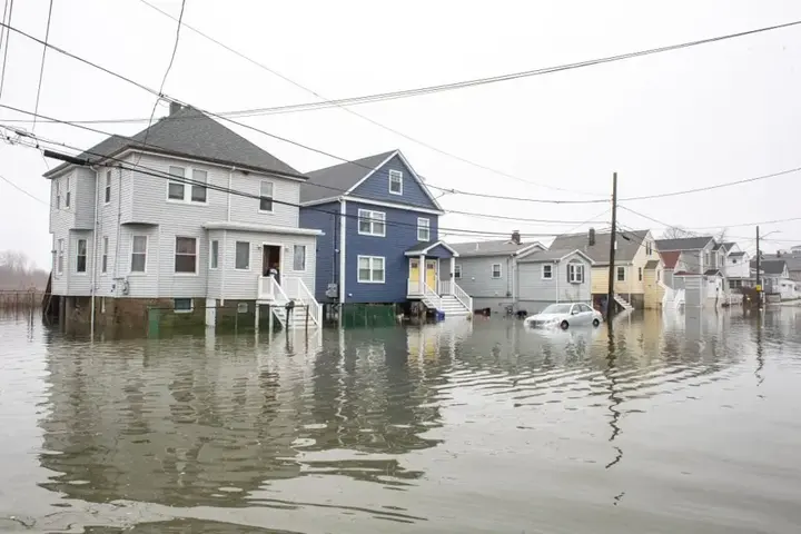 Floodwater around multi-family houses after a New England storm